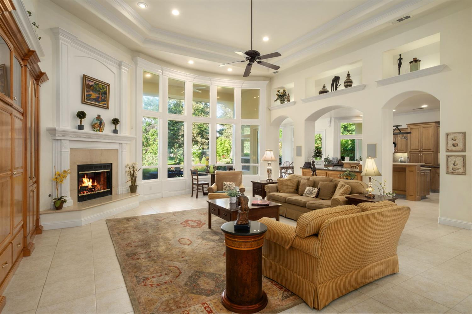 3386 East Vía Monte Verdi Clovis, CA 93619 - Photo 6 of 51 a living room with furniture large window and fireplace