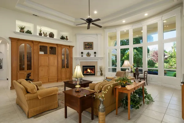 a living room with furniture fireplace and a large window