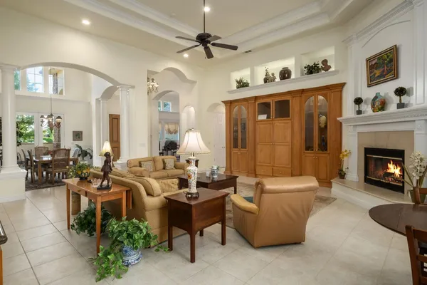 a living room with furniture fireplace and a chandelier