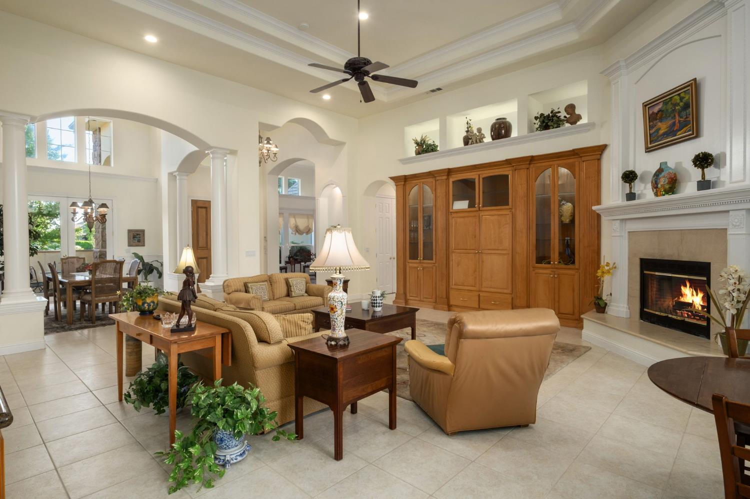 3386 East Vía Monte Verdi Clovis, CA 93619 - Photo 9 of 51 a living room with furniture fireplace and a chandelier