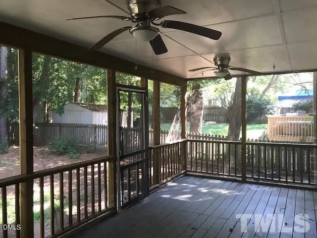 a view of a porch with wooden floor