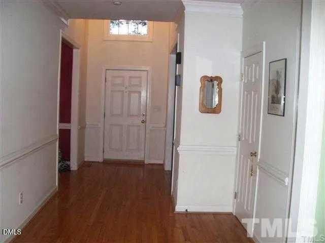 a view of a hallway with wooden floor