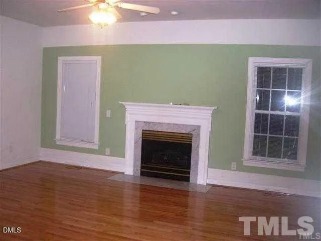 a view of a livingroom with a fireplace and wooden floor