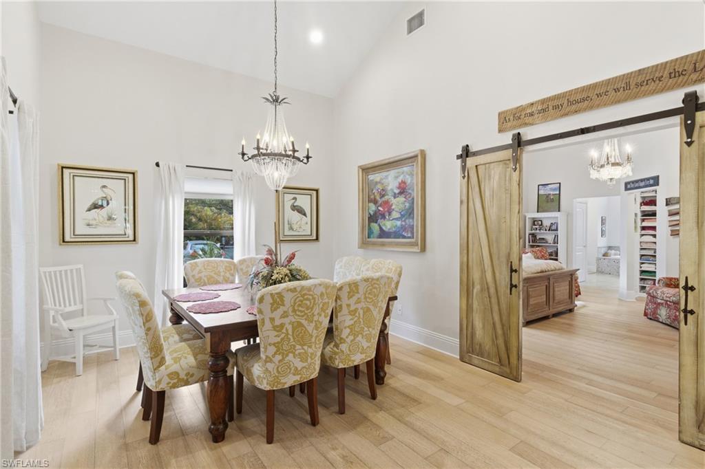 3800 Staley Road Fort Myers, FL 33905 - Photo 26 of 50 a view of a dining room with furniture wooden floor and a chandelier