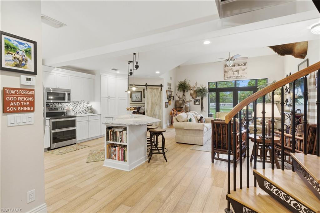 3800 Staley Road Fort Myers, FL 33905 - Photo 27 of 50 a view of a dinning room and kitchen with furniture wooden floor and windows