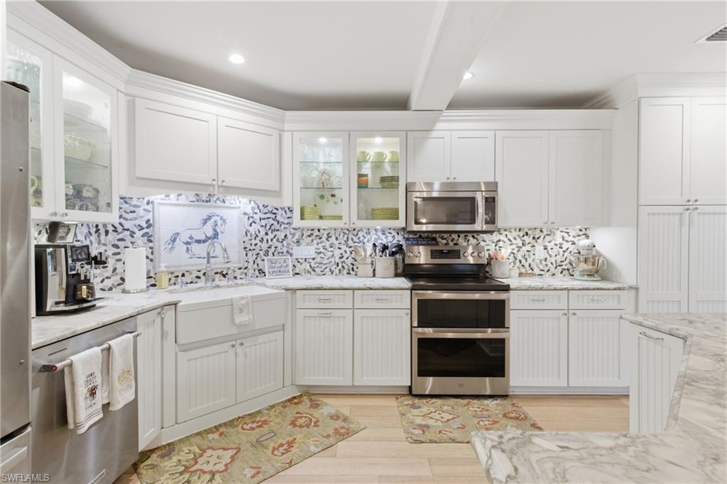 3800 Staley Road Fort Myers, FL 33905 - Photo 29 of 50 a kitchen with stainless steel appliances granite countertop a stove a sink and a microwave
