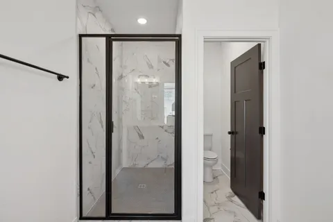 a bathroom with a glass shower door