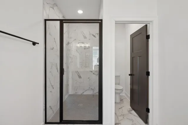a bathroom with a glass shower door