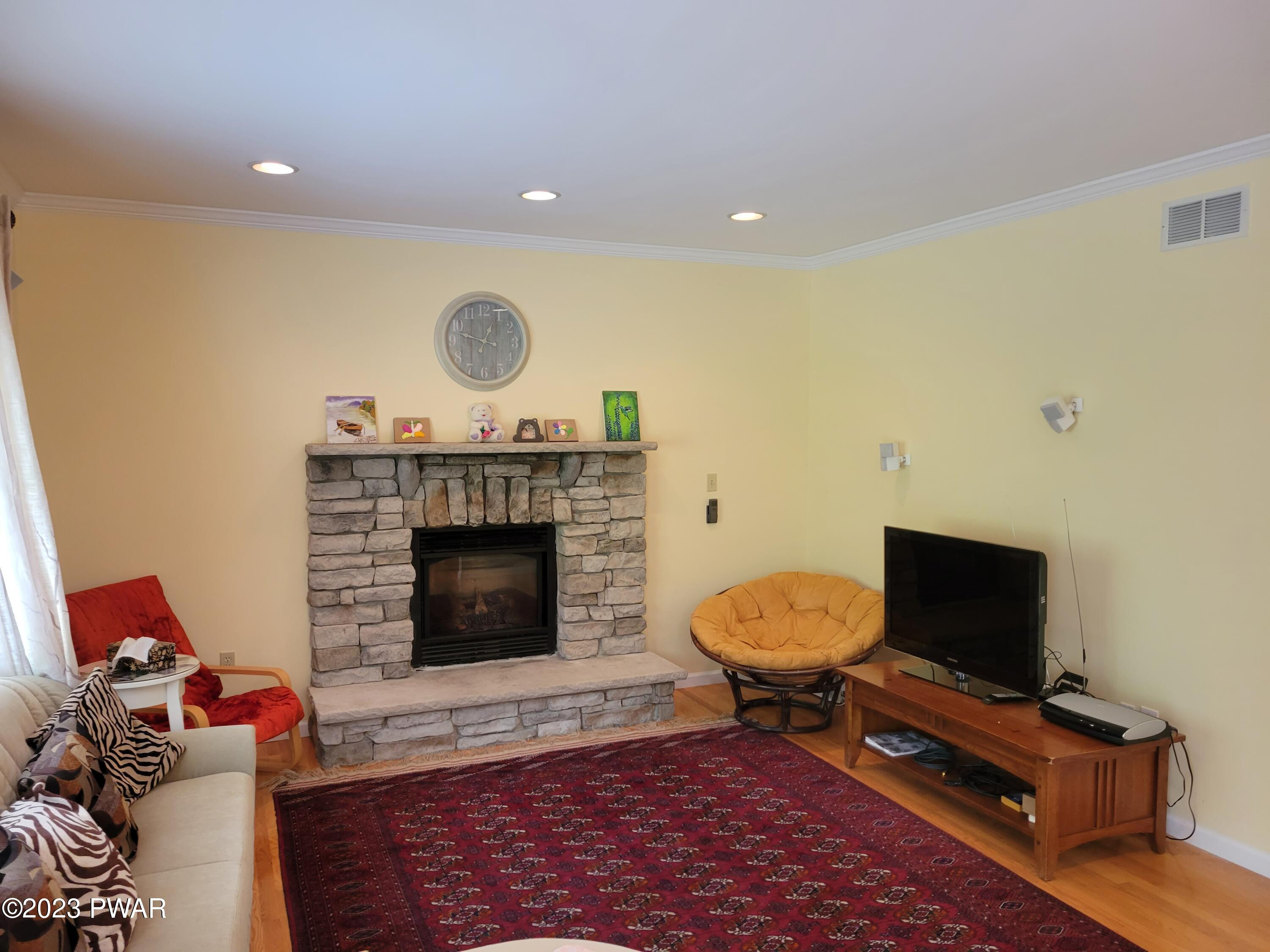 110 Rodeo Lane Hawley, PA 18428 - Photo 14 of 36 a living room with furniture and a fireplace