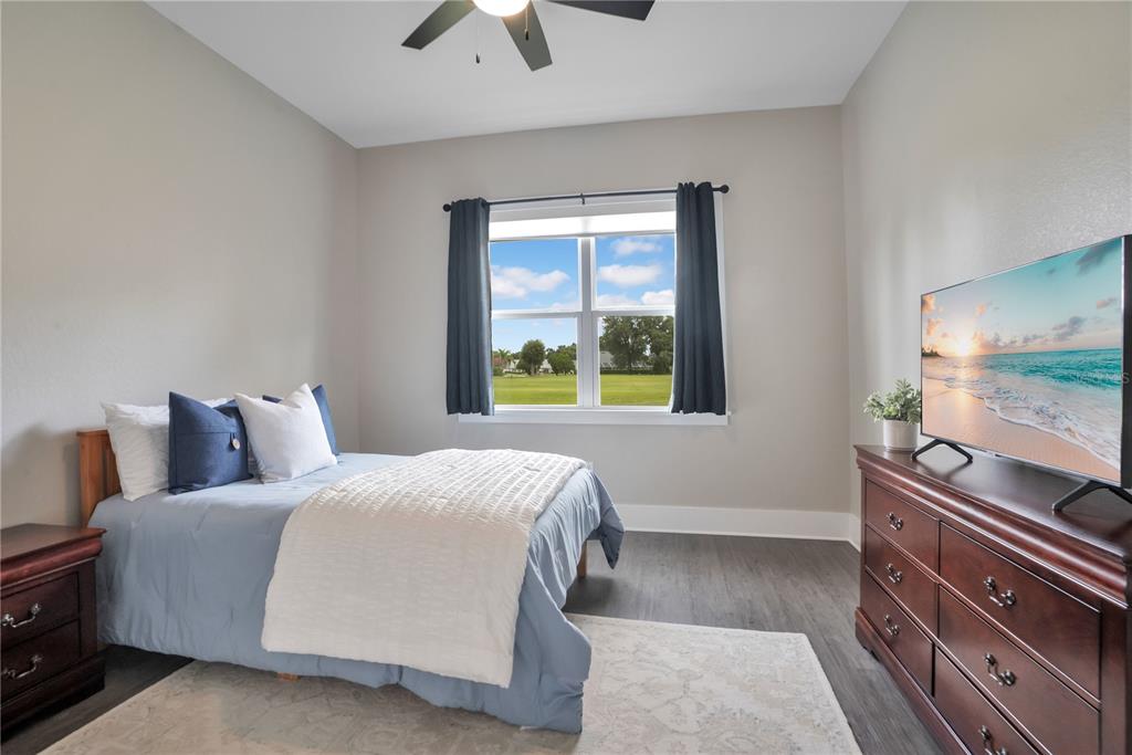440 Palma Ceia Road Winter Haven, FL 33884 - Photo 38 of 78 a bedroom with a bed and a flat tv screen on dresser