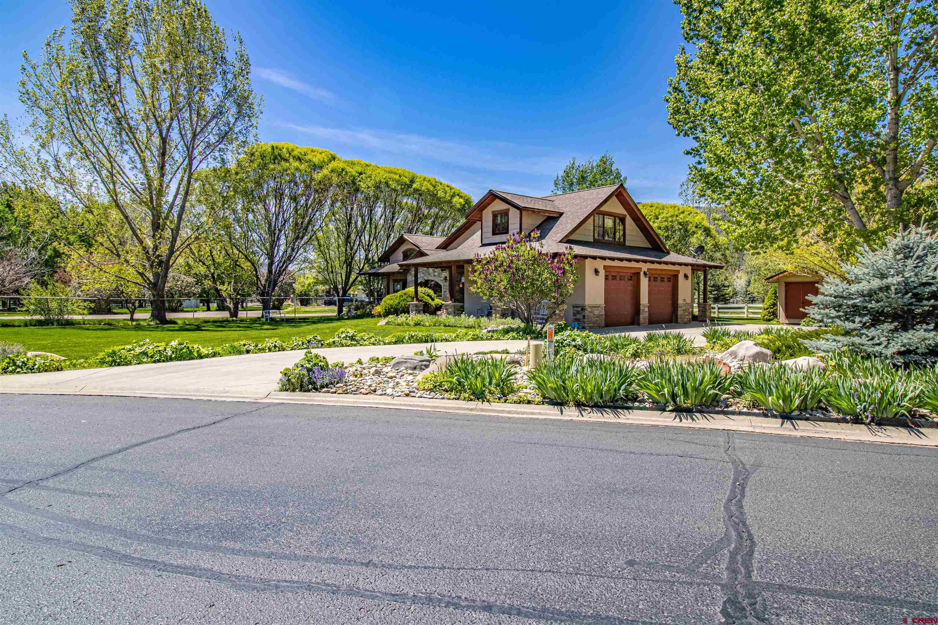 1167 North Dalton Ranch Road Durango, CO 81301 - Photo 3 of 45 a front view of a house with a yard and potted plants