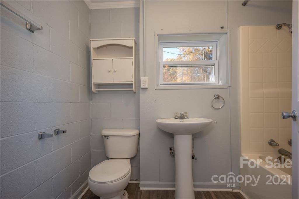 135 North Ridgecrest Avenue Rutherfordton, NC 28139 - Photo 13 of 18 a bathroom with a toilet sink and mirror
