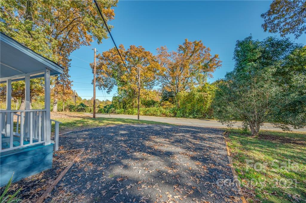 135 North Ridgecrest Avenue Rutherfordton, NC 28139 - Photo 3 of 18 a view of a yard with plants and large trees