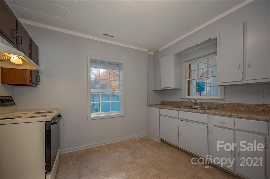 135 North Ridgecrest Avenue Rutherfordton, NC 28139 - Photo 6 of 18 a kitchen with stainless steel appliances granite countertop a sink stove and microwave