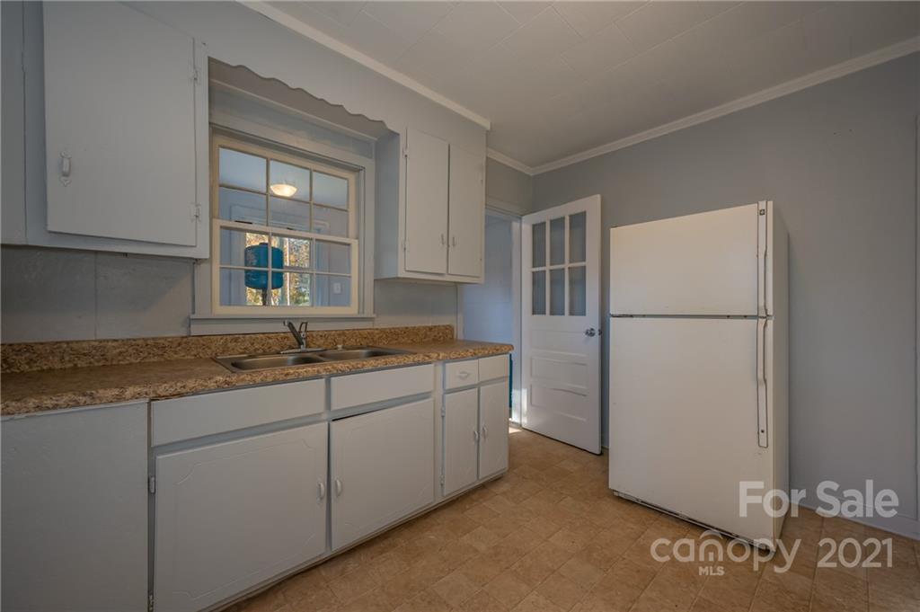 135 North Ridgecrest Avenue Rutherfordton, NC 28139 - Photo 8 of 18 a kitchen with stainless steel appliances granite countertop a refrigerator and a sink