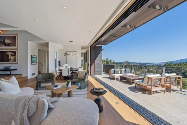 a living room with furniture and a floor to ceiling window