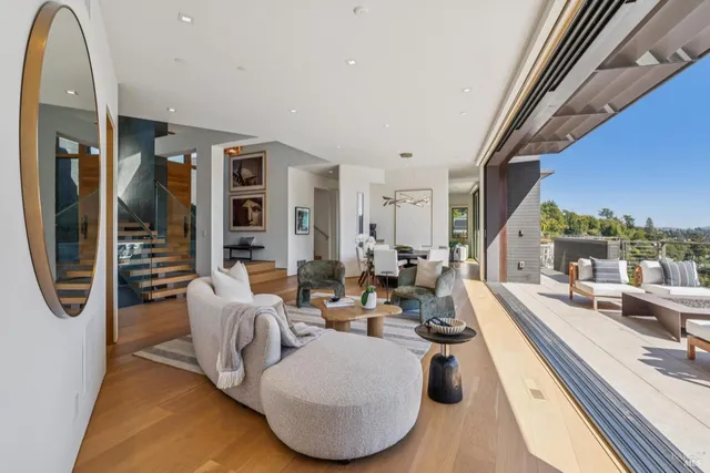 a dining hall with stainless steel appliances granite countertop a sink dishwasher and a flat tv screen next to a window