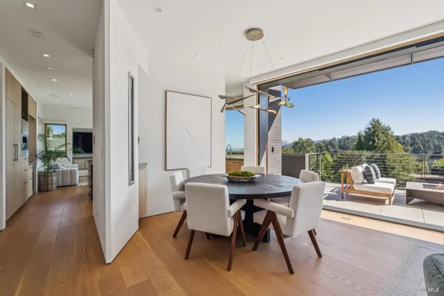 a roof deck with couches and wooden floor