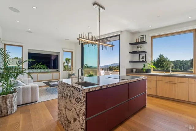 a kitchen with stainless steel appliances granite countertop a sink and a refrigerator
