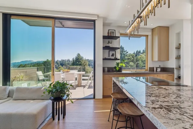 a kitchen with granite countertop a refrigerator and a stove top oven