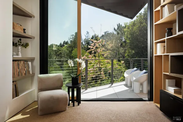 a view of a balcony with floor to ceiling windows and yard