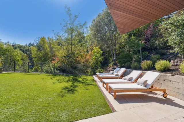 a view of a patio with couches table and chairs and potted plants