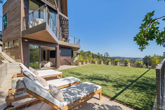 a living room with furniture and a floor to ceiling window