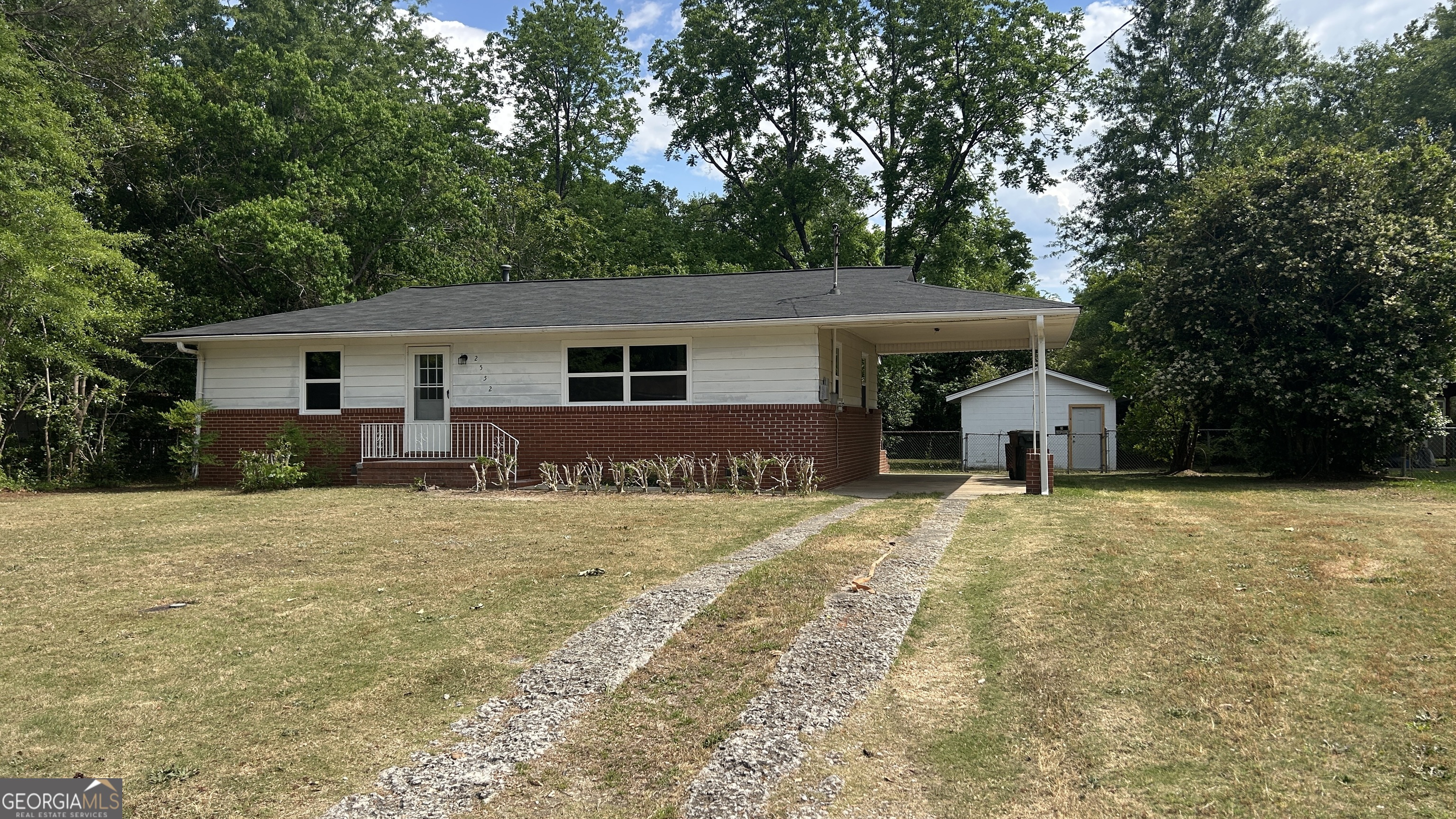 a front view of house with yard and trees