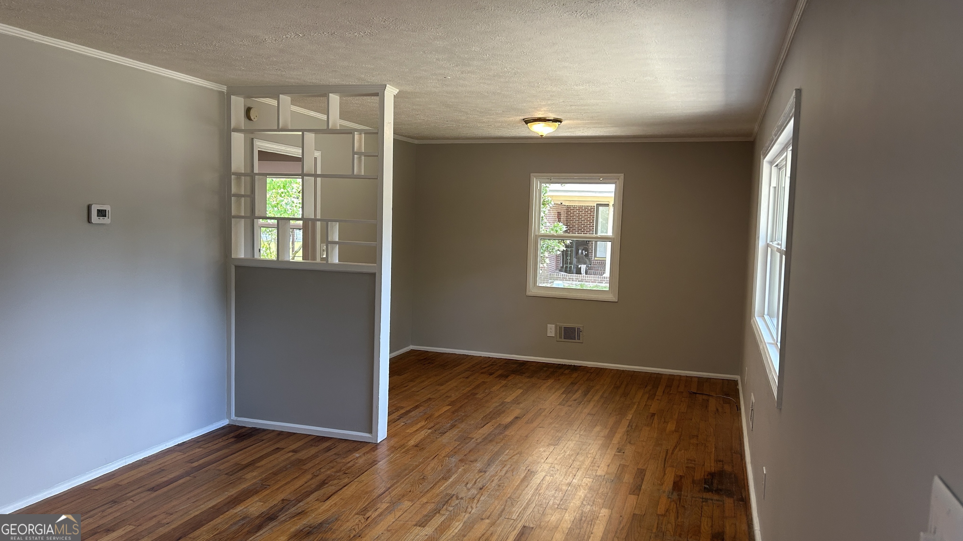 2552 Allan Way Macon, GA 31206 - Photo 4 of 14 an empty room with wooden floor and windows