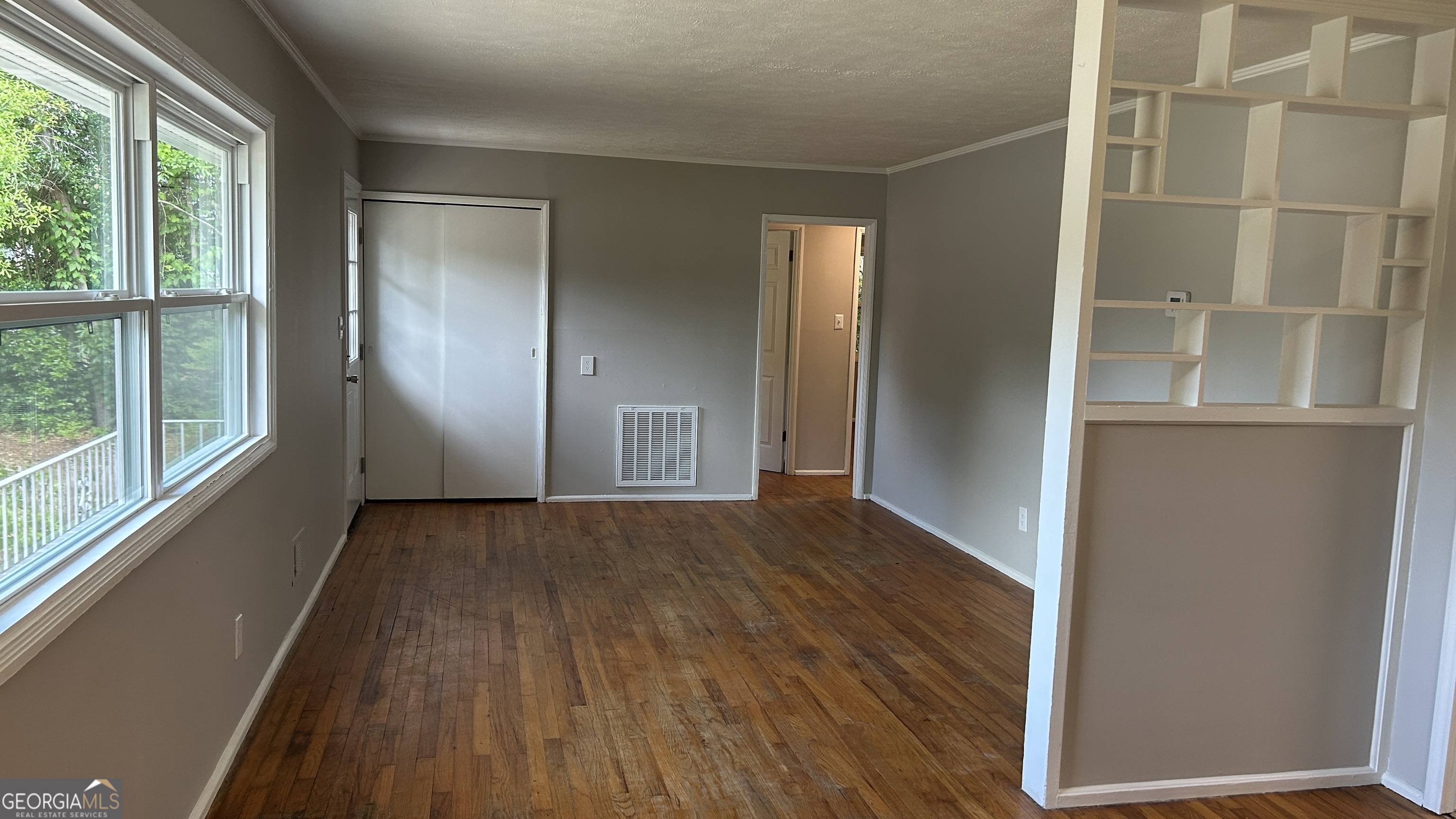 2552 Allan Way Macon, GA 31206 - Photo 5 of 14 an empty room with wooden floor and windows
