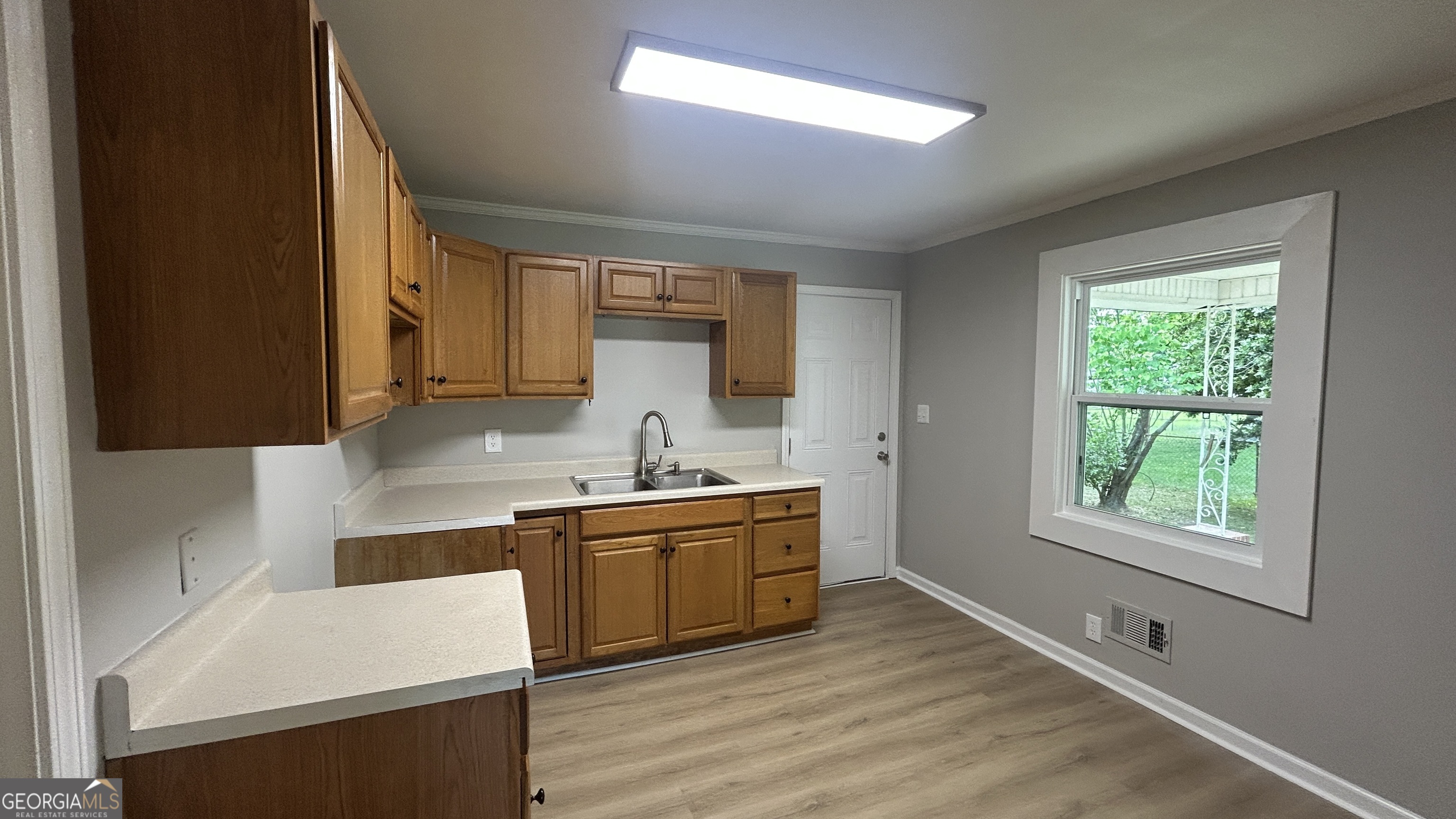 2552 Allan Way Macon, GA 31206 - Photo 6 of 14 a kitchen with a sink stove and cabinets