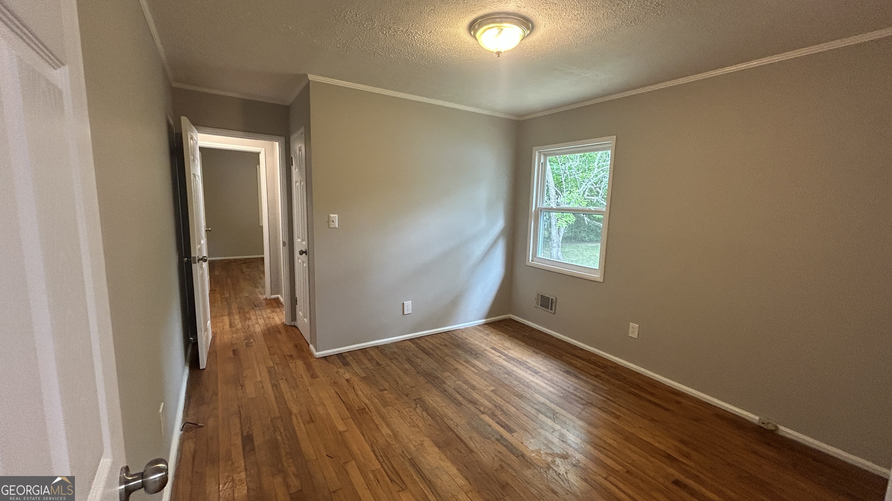 2552 Allan Way Macon, GA 31206 - Photo 7 of 14 an empty room with wooden floor and a window