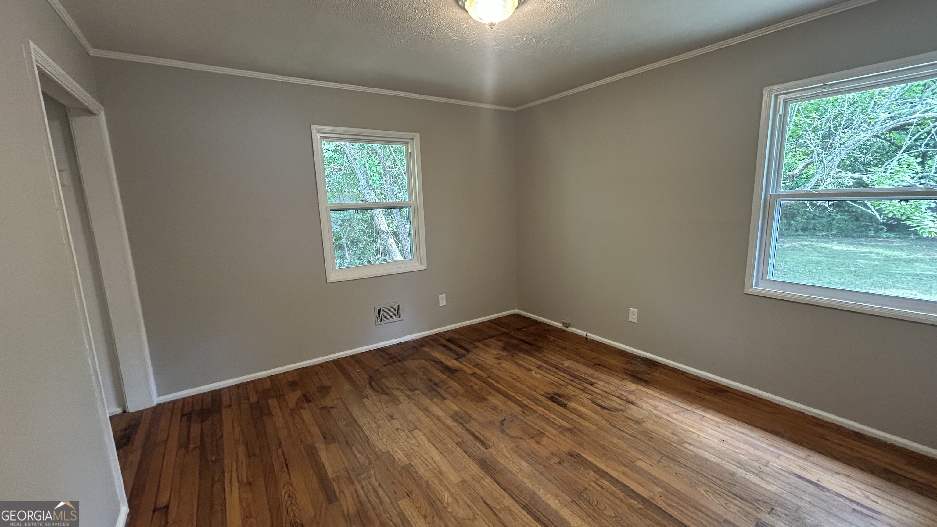 2552 Allan Way Macon, GA 31206 - Photo 9 of 14 a view of an empty room with wooden floor and a window