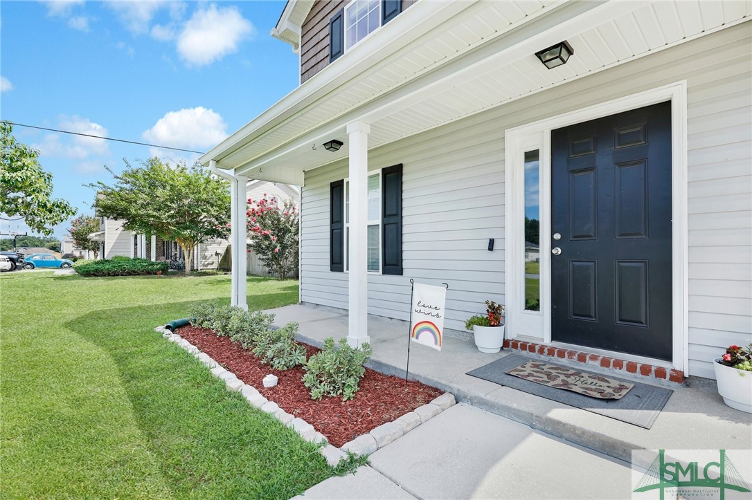 104 Laurel Lane Guyton, GA 31312 - Photo 4 of 47 The front porch is just waiting for your rocking c