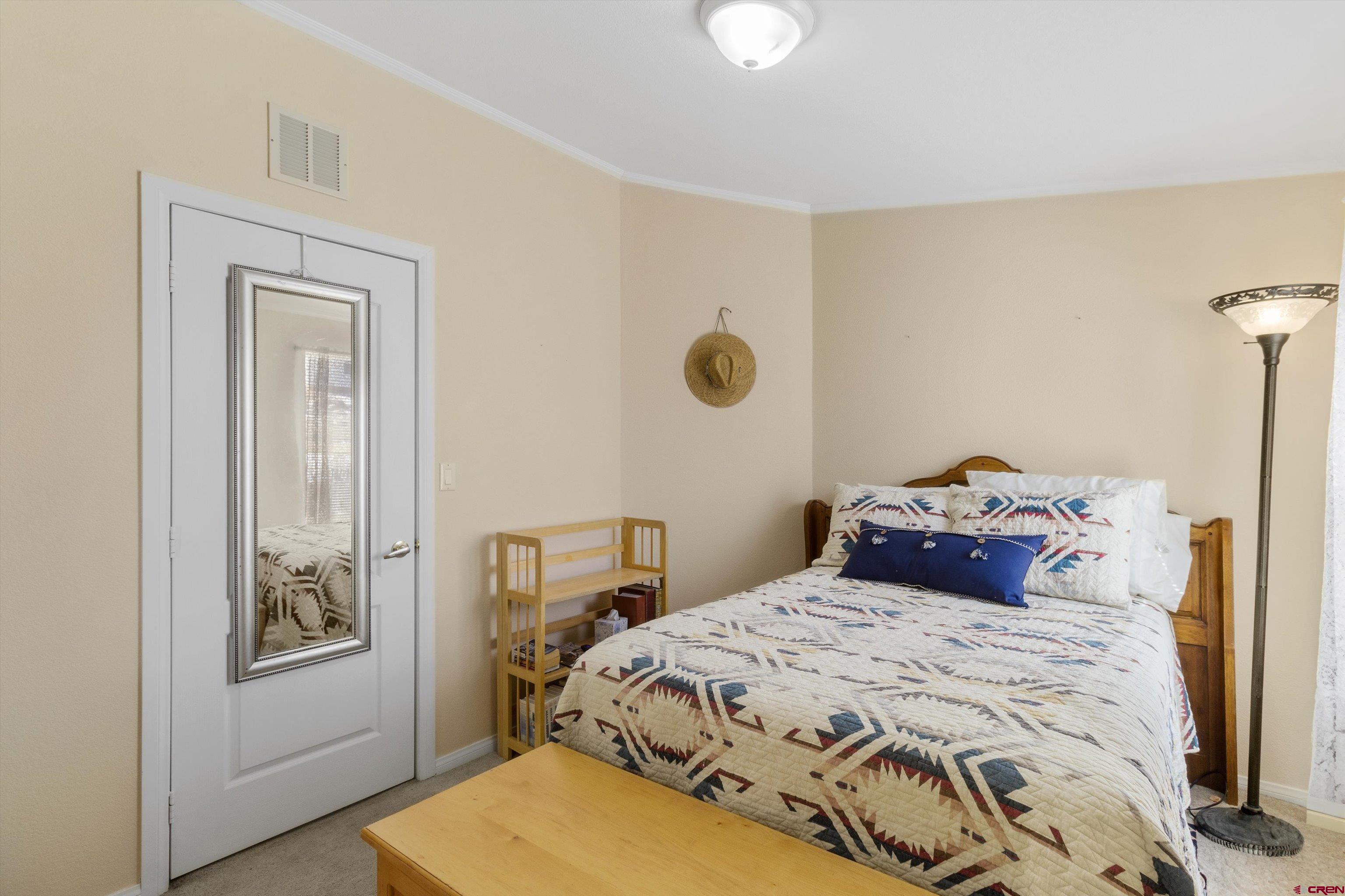 34 Silverview Court Durango, CO 81303 - Photo 23 of 29 a bedroom with a bed and a mirror