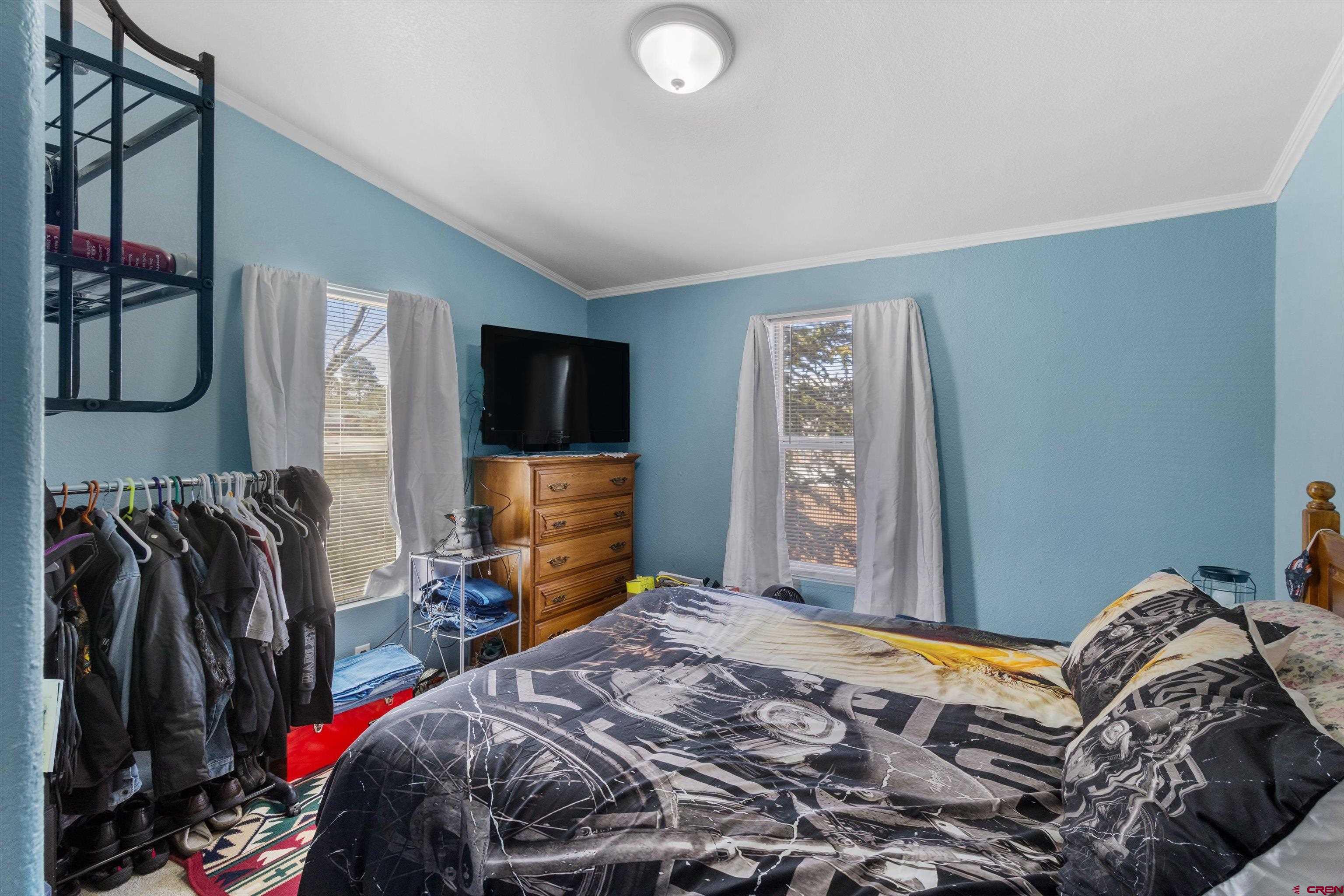 34 Silverview Court Durango, CO 81303 - Photo 26 of 29 a bedroom with a bed and a flat tv screen on the dresser