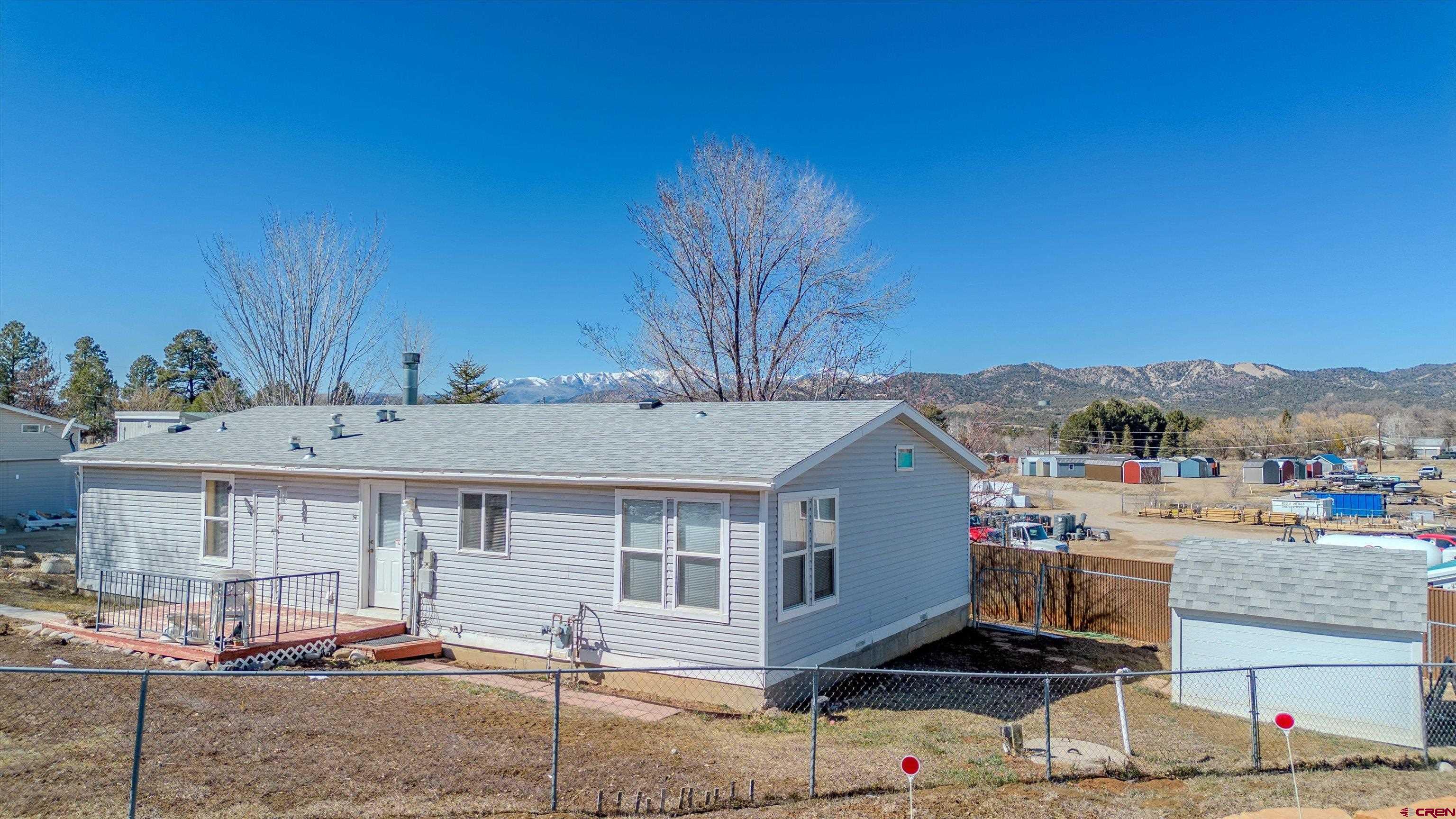 34 Silverview Court Durango, CO 81303 - Photo 3 of 29 a view of a white house with a sink and lawn chairs