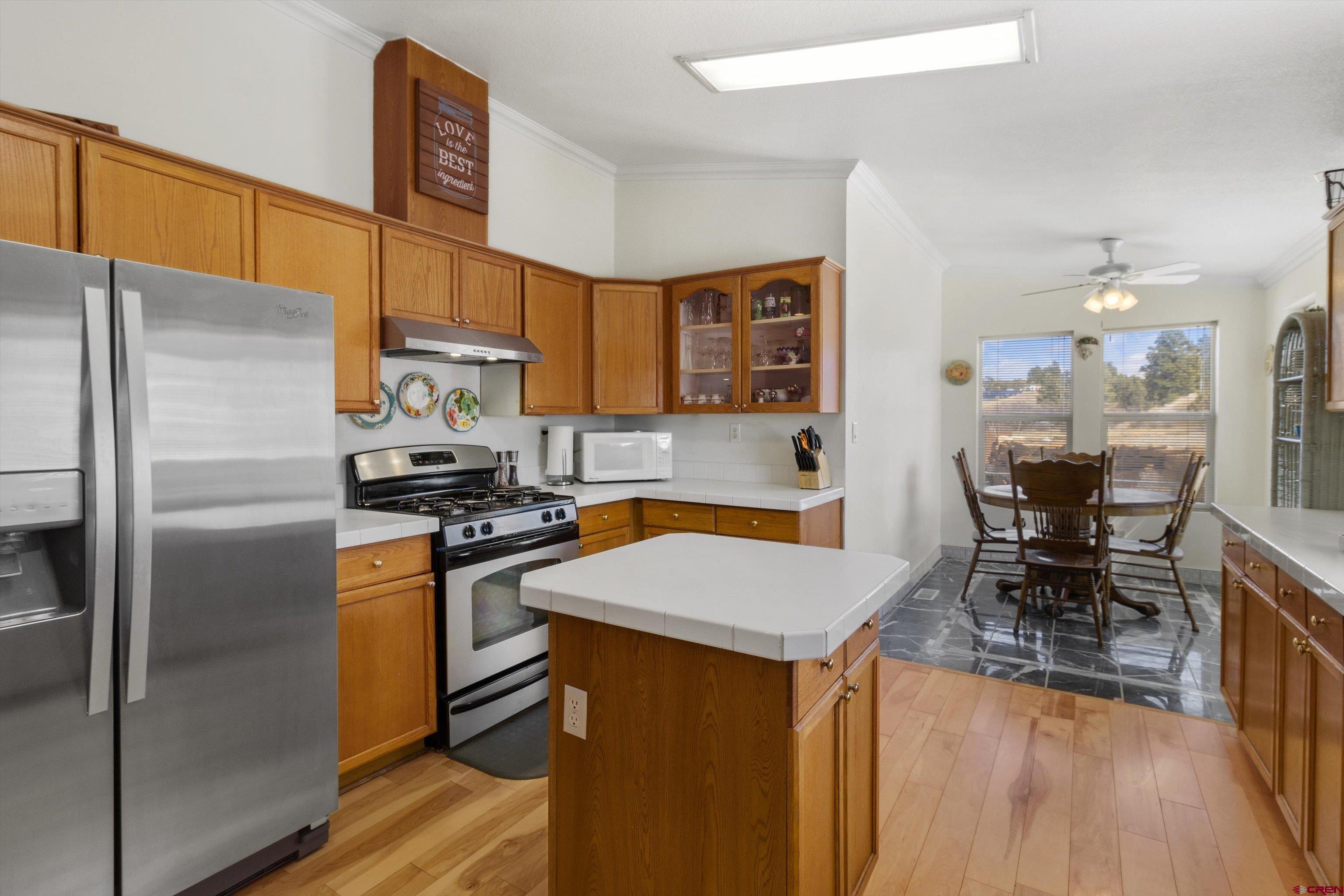 34 Silverview Court Durango, CO 81303 - Photo 8 of 29 a kitchen with stainless steel appliances a refrigerator a stove a sink a dining table and chairs