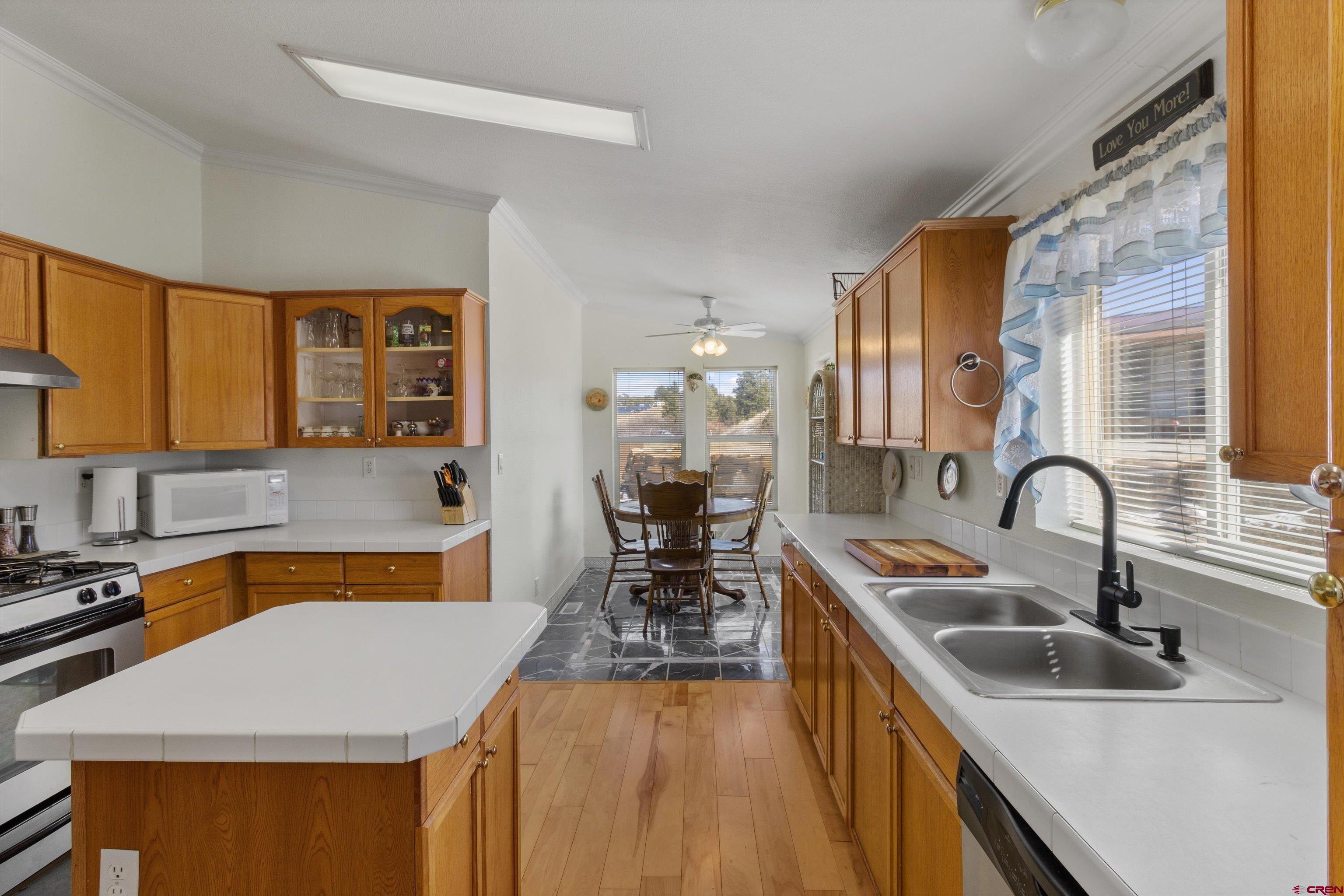 34 Silverview Court Durango, CO 81303 - Photo 9 of 29 a kitchen with a sink a stove and chairs