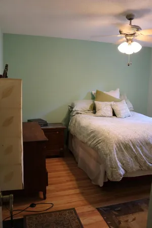 a bedroom with a bed and a chandelier