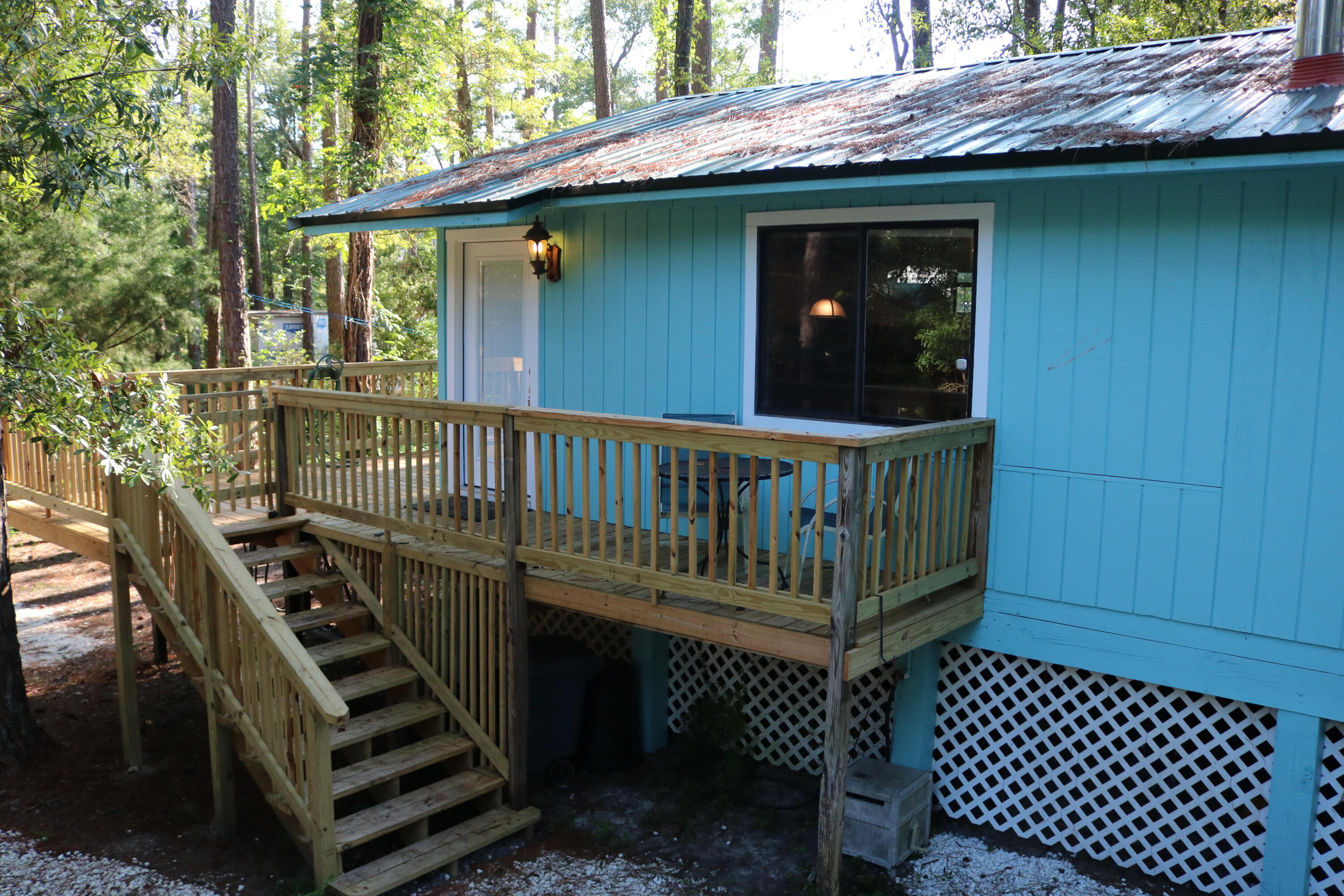 265 Howell Bluff Road Ponce de Leon, FL 32455 - Photo 2 of 18 a view of a wooden deck with a bench