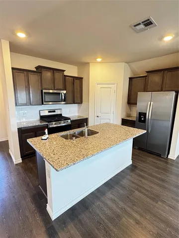a room with wooden floors and furniture