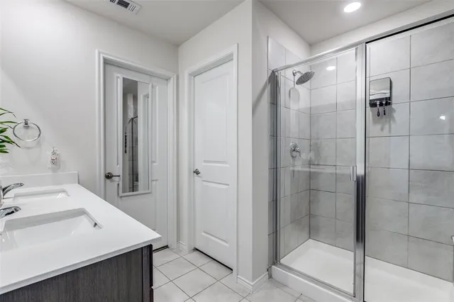 a bathroom with a sink shower and a mirror