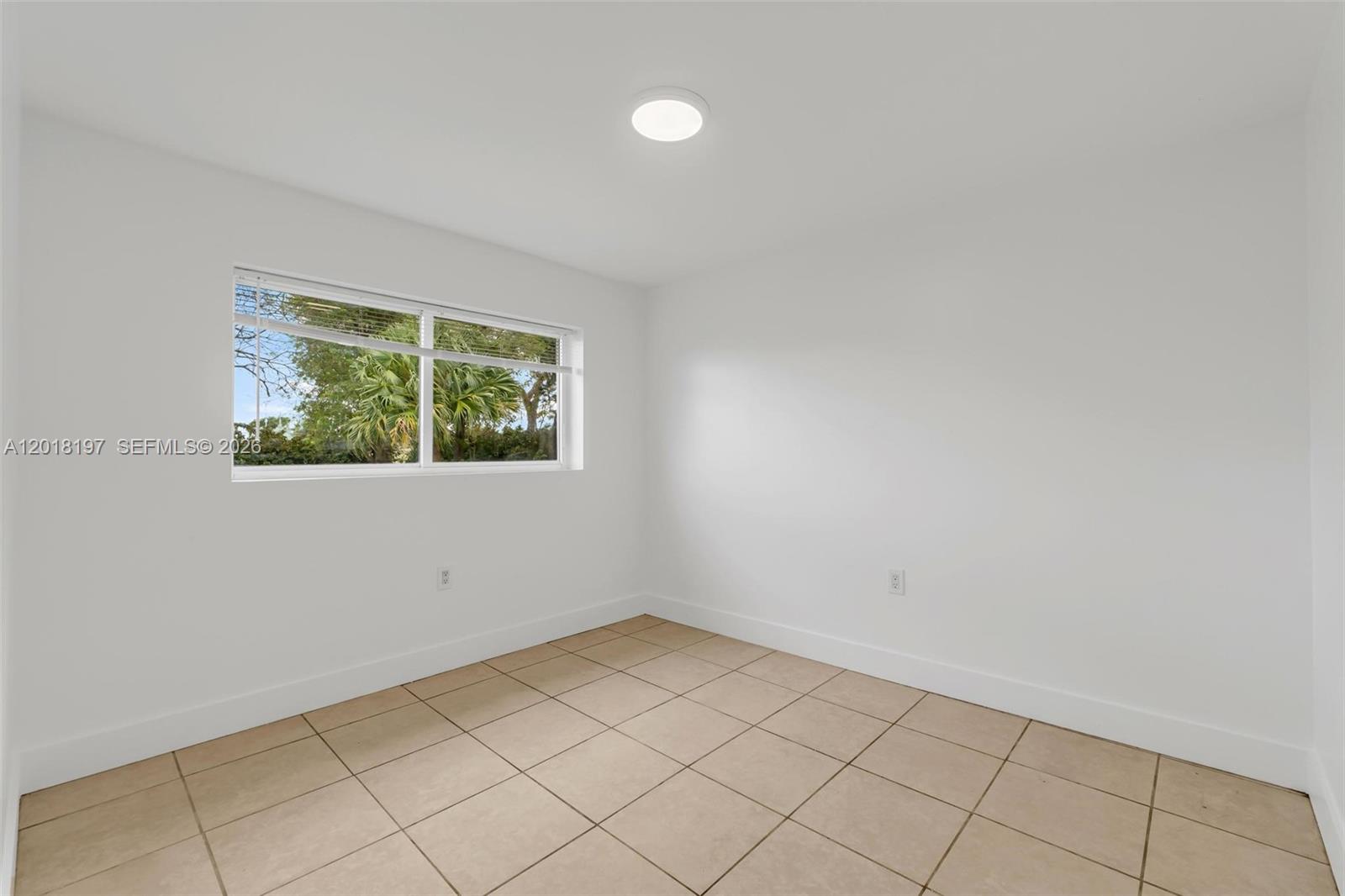 628 Southwest 8th Avenue Homestead, FL 33030 - Photo 17 of 25 an empty room with a window