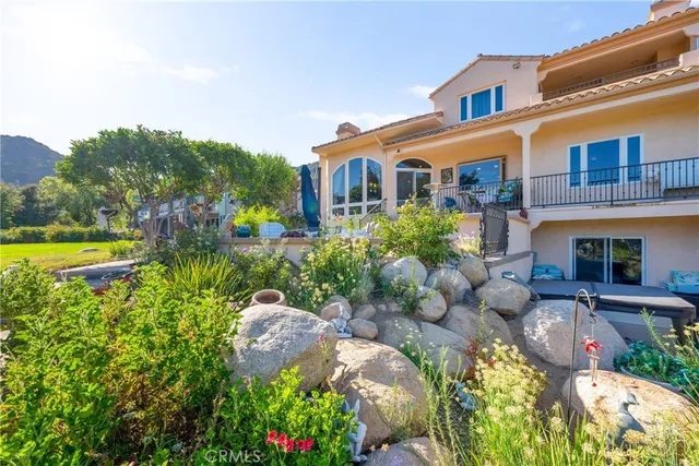 a front view of a house with a yard and fountain