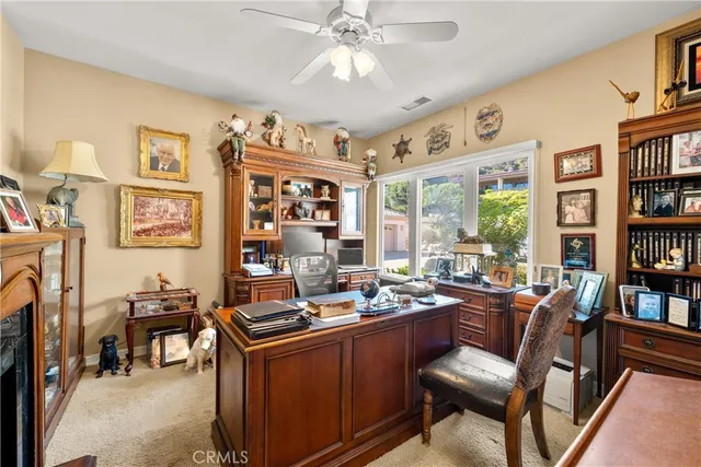a room with furniture a bookshelf and a window