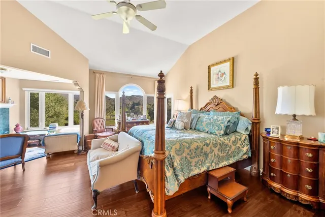 a bedroom with furniture and a large window