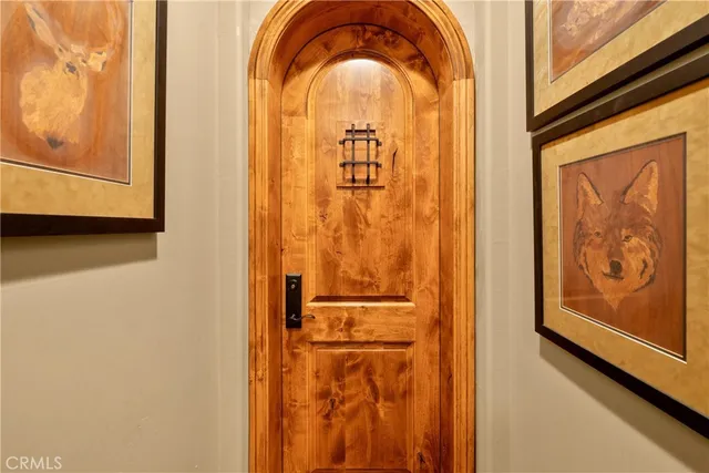 a living room with furniture a large window and wooden floor