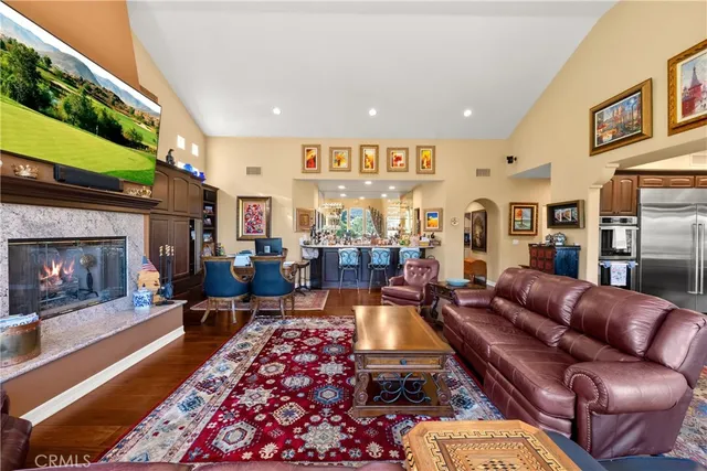 a living room with furniture fireplace and a large window