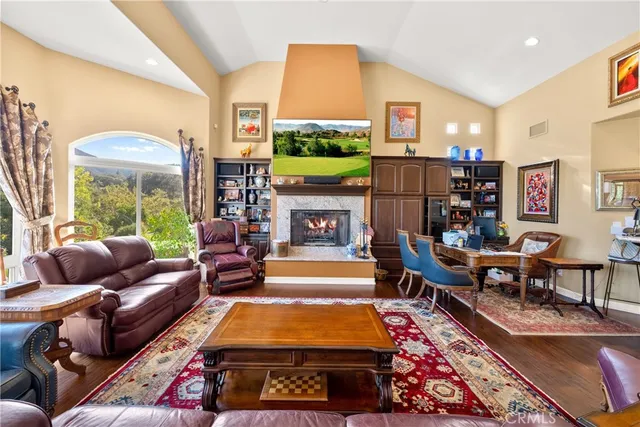 a living room with fireplace furniture and a large window